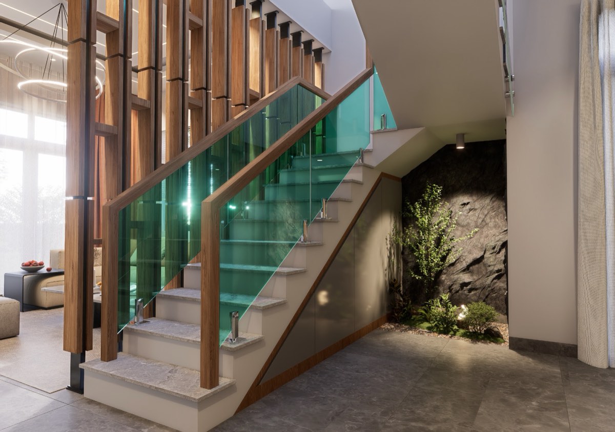 Staircase with a glass balustrade and a planted rock garden beneath the flight